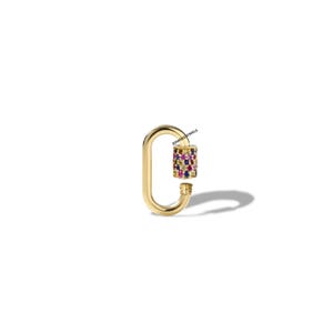 May include: A gold-coloured, oval-shaped clasp with a cylindrical centre. The centre is encrusted with a variety of colourful gemstones, including red, blue, yellow, and pink. The clasp is designed to open and close.