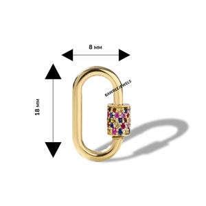 May include: A gold-coloured oval-shaped clasp with a cylinder of colourful gemstones. The clasp measures 1.8 cm in length and 0.8 cm in width. The text "BAWREEJEWELS" is visible on the clasp.