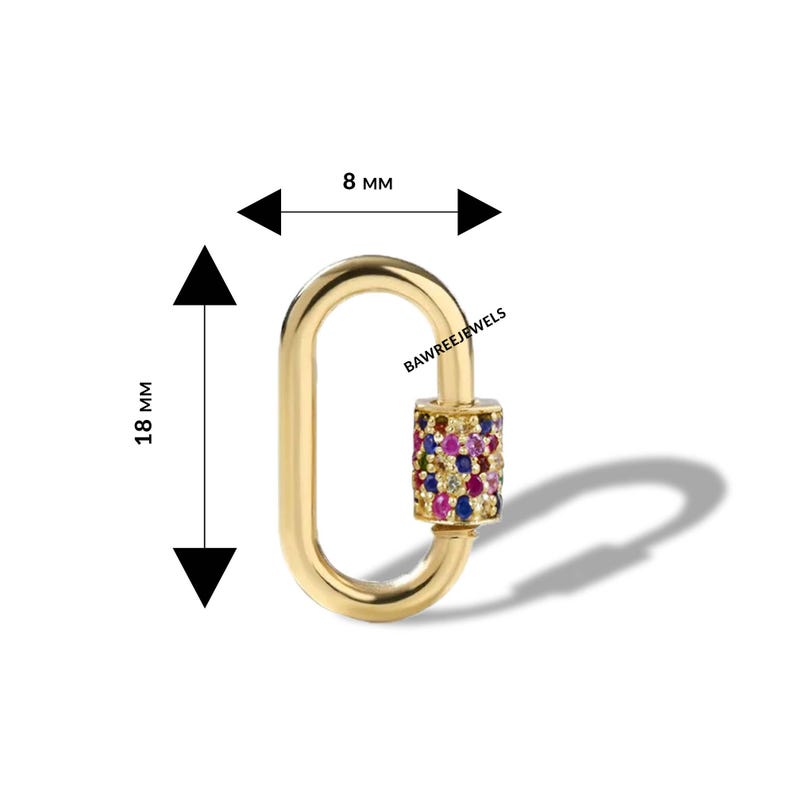 May include: A gold-coloured oval-shaped clasp with a cylinder of colourful gemstones. The clasp measures 1.8 cm in length and 0.8 cm in width. The text "BAWREEJEWELS" is visible on the clasp.