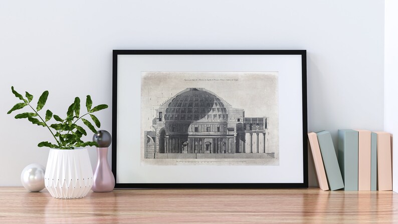 Puede incluir: Impresi&oacute;n vintage en blanco y negro de una secci&oacute;n transversal de un edificio con c&uacute;pula y columnas. La impresi&oacute;n est&aacute; enmarcada en un marco negro y se muestra en un estante de madera con una planta en maceta y otros art&iacute;culos decorativos.