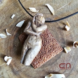 Naked female body necklace. Pendant hand carved in walnut wood (the body) and mahogany wood (the back base).