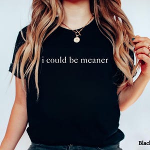 May include: A black t-shirt with the text "i could be meaner" printed in white on the front.