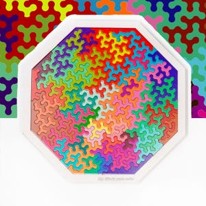 May include: An octagonal wooden puzzle with a white frame, filled with colourful interlocking pieces. The puzzle pieces are in shades of red, orange, yellow, green, blue, and purple. The text "High difficulty puzzle series" is visible at the bottom.