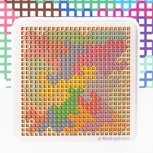 Puede incluir: Un rompecabezas cuadrado blanco con un diseño geométrico colorido. El rompecabezas presenta un patrón de cuadrícula con formas entrelazadas en tonos de rosa, verde, azul, amarillo y morado. El texto "gh difficulty puzzle series" está en la esquina inferior derecha.