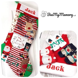 May include: A red and green Christmas stocking with a patchwork design featuring reindeer, Santa, and the text "Mommy's little deer!" and "My first Christmas". The stocking is personalised with the name "Jack".