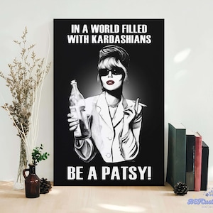 May include: Black and white poster featuring a woman in sunglasses holding a bottle and cigarette. The text at the top reads "IN A WORLD FILLED WITH KARDASHIANS" and the bottom reads "BE A PATSY!"