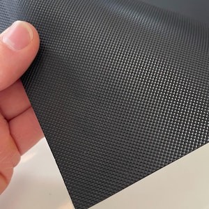 May include: Black textured rubber sheet with a diamond pattern.