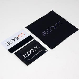 May include: A black cleaning cloth with the word "BLOQ.CC" printed in white. A white and black card with the same logo is also shown. A small black pouch with the same logo and the text "70% Isopropyl Alcohol Wipes" is also shown.