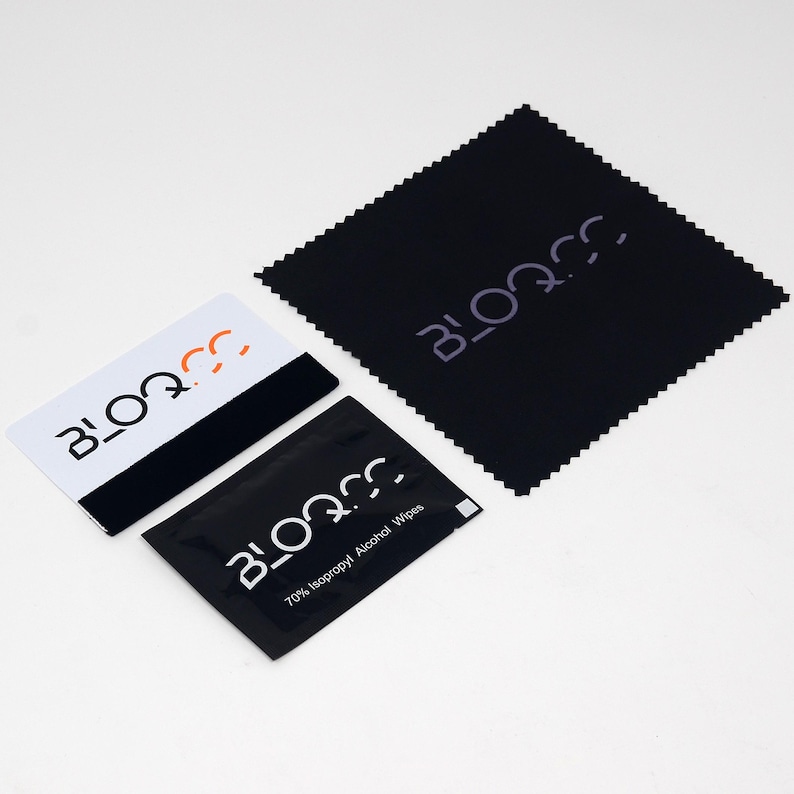 May include: A black cleaning cloth with the word "BLOQ.CC" printed in white. A white and black card with the same logo is also shown. A small black pouch with the same logo and the text "70% Isopropyl Alcohol Wipes" is also shown.