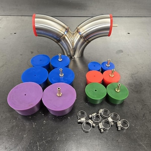 May include: A stainless steel Y-pipe with red and blue silicone caps and green silicone caps. The pipe has two inlets and one outlet. There are also several silver hose clamps.