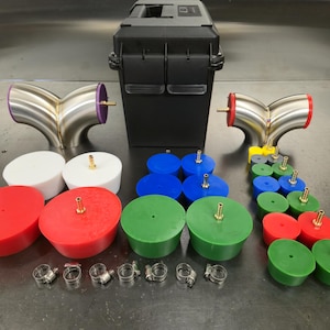 May include: An assortment of automotive parts, including stainless steel Y-pipes with purple and red accents, various colored plugs, clamps, and a black storage case. The plugs are in red, green, blue, white, and yellow.