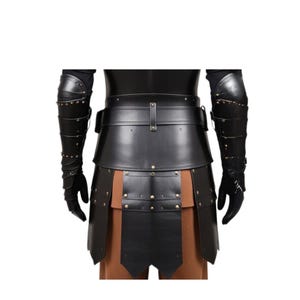 May include: Black leather armor with a skirt and arm guards. The armor has a belt with a buckle and is decorated with metal studs.