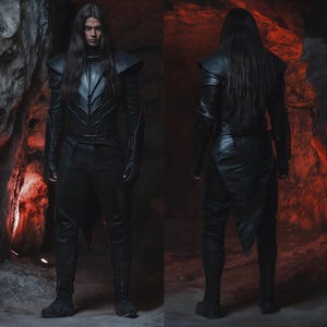 Pu&ograve; includere: Una persona indossa un costume in pelle nera con una lunga parrucca nera. Il costume presenta un lungo mantello fluido e dettagli intricati. La persona &egrave; in piedi in un ambiente buio e cavernoso.