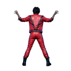 May include: A red leather jacket and matching red leather pants with black vertical stripes. The jacket features a V-shaped black leather design on the back. The outfit is paired with black boots, and the figure stands with arms raised.