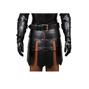 May include: Black leather armor with a belt and studded details. The armor includes gauntlets and a skirt.