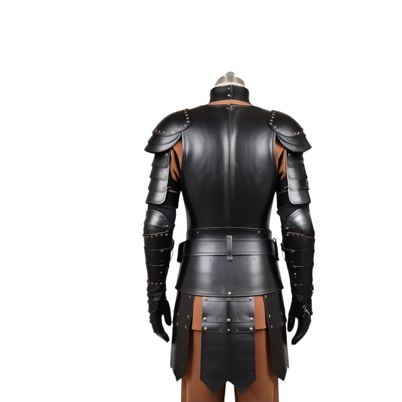 May include: Black leather armor with studded details. The armor includes a chest piece, shoulder pads, and arm guards. The armor is worn on a mannequin.