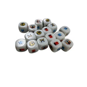 May include: A collection of white dice with various colorful symbols on each face. The symbols include a yellow sun, a red rectangle, a blue bird, and a black and yellow design. The dice are scattered on a white surface.