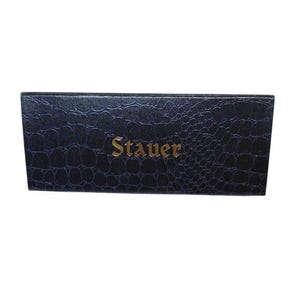 May include: A rectangular box with a dark blue, textured exterior. The word "Stauer" is printed in gold lettering on the front of the box. The box has a reptile skin pattern.