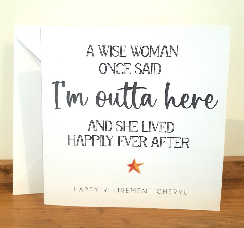 May include: A white card with black text that reads "A wise woman once said I'm outta here and she lived happily ever after." A small orange star is below the text. The text "Happy Retirement Cheryl" is at the bottom of the card.