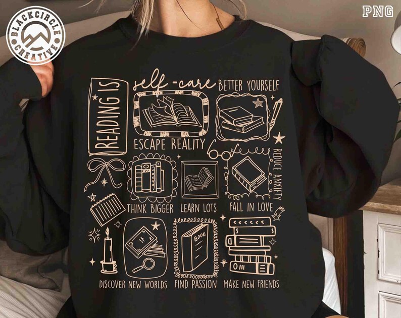 May include: Black sweatshirt with a cream-colored graphic featuring book illustrations and phrases like "self-care," "escape reality," and "discover new worlds." The design includes a logo in the upper left corner.
