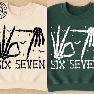 May include: Two sweatshirts, one cream and one dark green, each featuring a skeleton hand design forming the numbers six and seven. The design includes bats and stars, with the text "SIX SEVEN" below.
