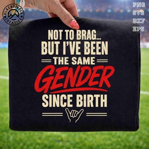 May include: Black t-shirt with the text "NOT TO BRAG... BUT I'VE BEEN THE SAME GENDER SINCE BIRTH" in white and red. The design includes a hand gesture and is suitable for various occasions.
