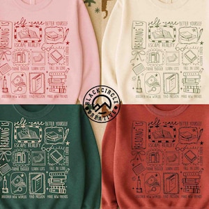 以下が含まれることがあります： ピンク、クリーム、グリーン、ラストカラーの4つのスウェットシャツ。それぞれに本をテーマにしたグラフィックが施されています。「Reading Is」というテキストや、「Escape Reality」や「Discover New Worlds」などのフレーズが含まれています。