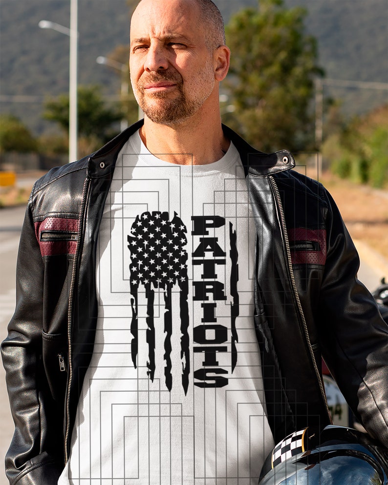 May include: A white t-shirt with a black and white distressed American flag design and the word "PATRIOTS" printed vertically on the right side of the flag.