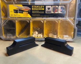 May include: Two black plastic organizers for a Stanley FatMax toolbox. The organizers are designed to fit inside the toolbox and have a slot for holding tools.