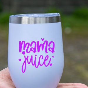 May include: White stainless steel tumbler with a purple inscription that reads "mama juice" with small hearts around the text.