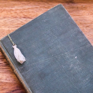 White tassel bookmark resting on the book cover.