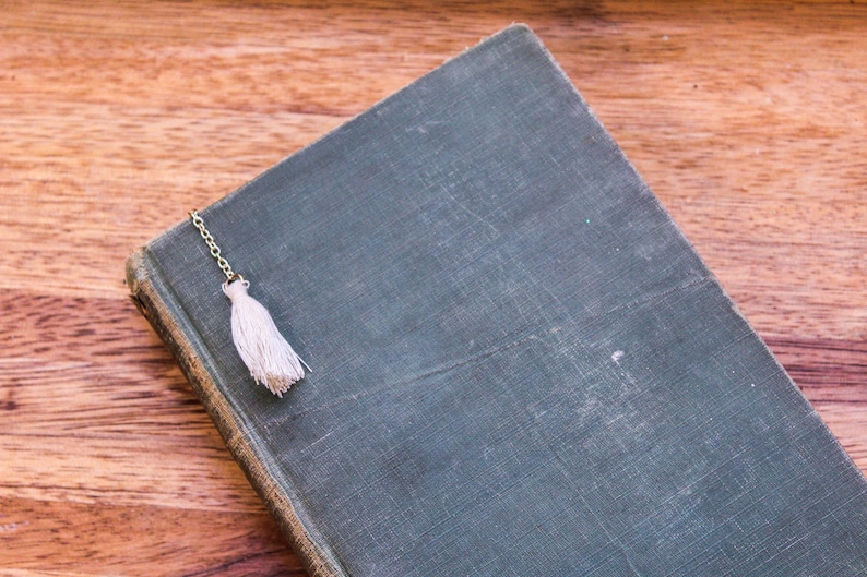 White tassel bookmark resting on the book cover.