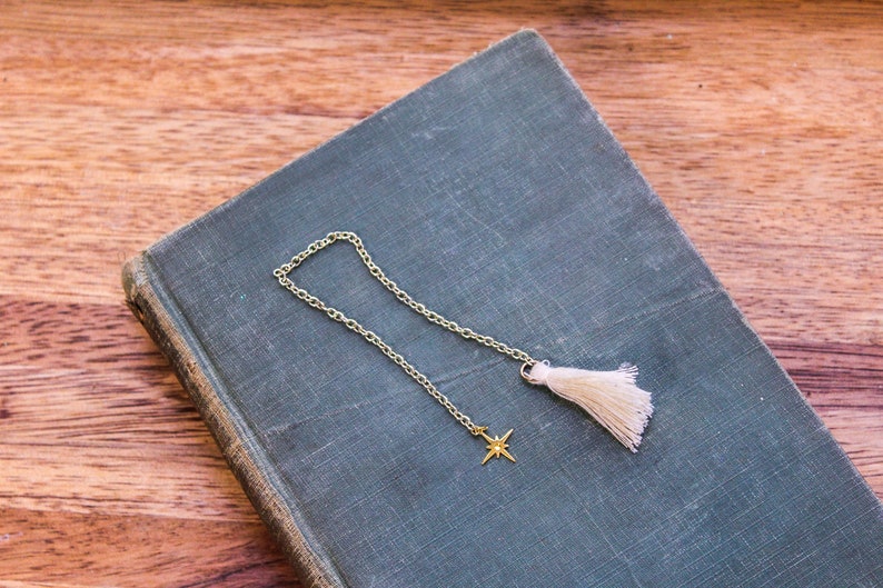 Short north star gold chain bookmark with tassel.