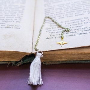 White tassel on one side of this simple charm chain bookmark.