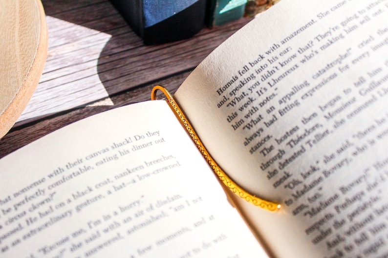 Hook bookmark sitting in an open book.