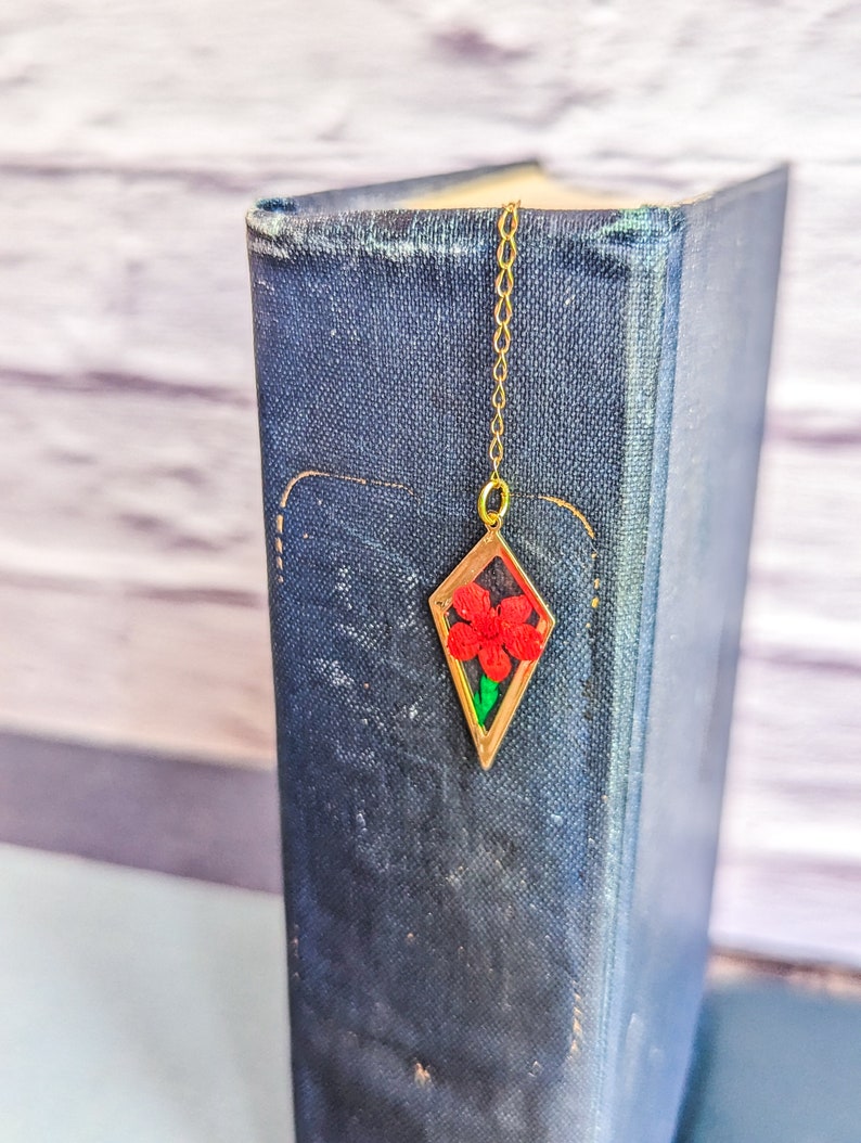 Red flower pressed and encased in resin.