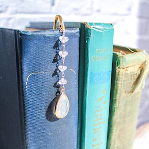 This bookmark has a short crystal and chain dangling over the bookmark.