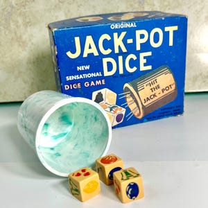 May include: Vintage "Jack-Pot Dice" game in a blue box with a white and green dice cup and four dice with fruit and bell symbols. The box says "Original Jack-Pot Dice" and "New Sensational Dice Game".