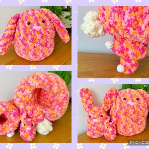May include: Three crocheted pink and orange bunny plushies. The largest bunny is sitting upright with its ears flopped over. The middle bunny is lying down with its head resting on its paws. The smallest bunny is sitting upright with its ears standing up.