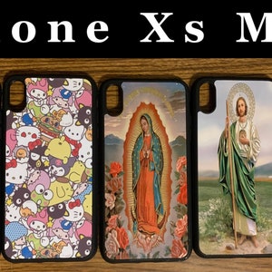 May include: Five different iPhone Xs Max phone cases. The cases are black with a variety of colorful designs. The designs include a Tinkerbell character, a Hello Kitty character, a religious image of the Virgin Mary, a religious image of Jesus, and a Winnie the Pooh character.