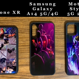 May include: Three different phone cases with various designs. The first case has a collage of chickens in a coop. The second case has a dark purple and black design with a cartoon character. The third case has a blue and red design with a fantasy character.