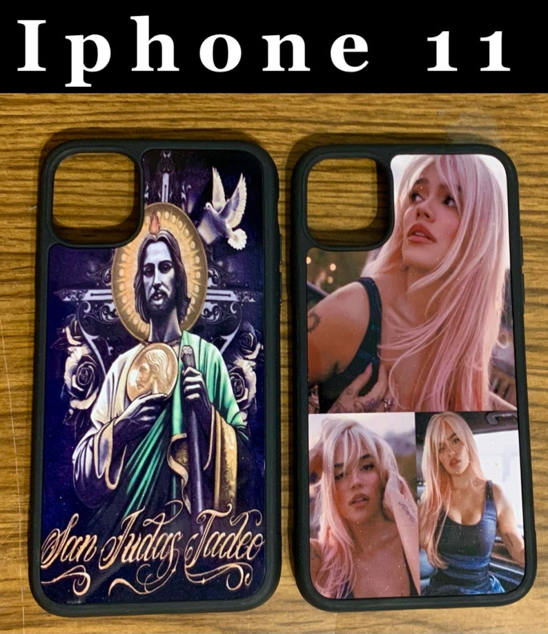 May include: Two black iPhone 11 cases. One case features a colorful image of a religious figure with the text "San Judas Tadeo". The other case features a collage of three images of a woman with pink hair.