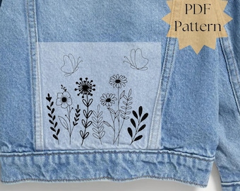 May include: Light blue denim jacket with a floral and butterfly design. The design features black line art of various flowers and butterflies. The words "PDF Pattern" are in a starburst shape on the upper right side of the jacket.