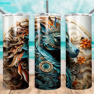 May include: A stainless steel tumbler with a colorful, abstract design featuring a blue and gold animal head with intricate details. The design is reminiscent of paper cutouts.