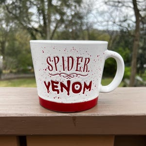 May include: A set of three ceramic nesting bowls in shades of blue, green, and white. The bowls feature a speckled glaze and a simple, modern design. The largest bowl measures approximately 6 inches in diameter.