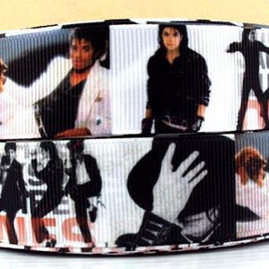 May include: Black and white ribbon featuring images of a performer in various poses. The ribbon has a repeating pattern of images, with a black background and white accents. The ribbon is likely used for crafting or decorative purposes.