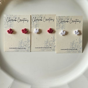 May include: Three cards with the text "Charcoal Creations" and images of red and white maple leaf earrings. The cards have a website address printed on the bottom.