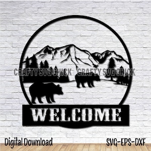 May include: Black and white silhouette of a mountain range with two bears and trees in a circle with the word "WELCOME" below.
