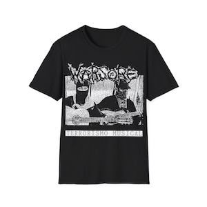 May include: Black t-shirt with a white graphic print of two figures wearing masks and holding a guitar. The text "WARRIORS" and "TERRORISMO MUSICAL" is printed on the shirt.