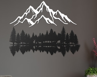 May include: Black metal wall art depicting a mountain range reflected in a lake with a forest in the foreground. The art is mounted on a gray wall in a living room setting.